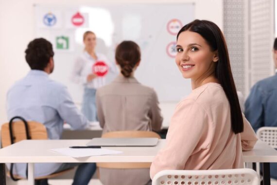 Woman smiling while taking classes at a DUI school to save on her SR-22 insurance - Cheap SR-22 Insurance