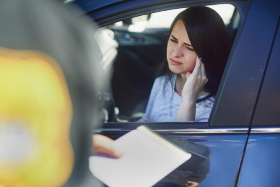 Woman driving drunk gets pulled over by police officer.